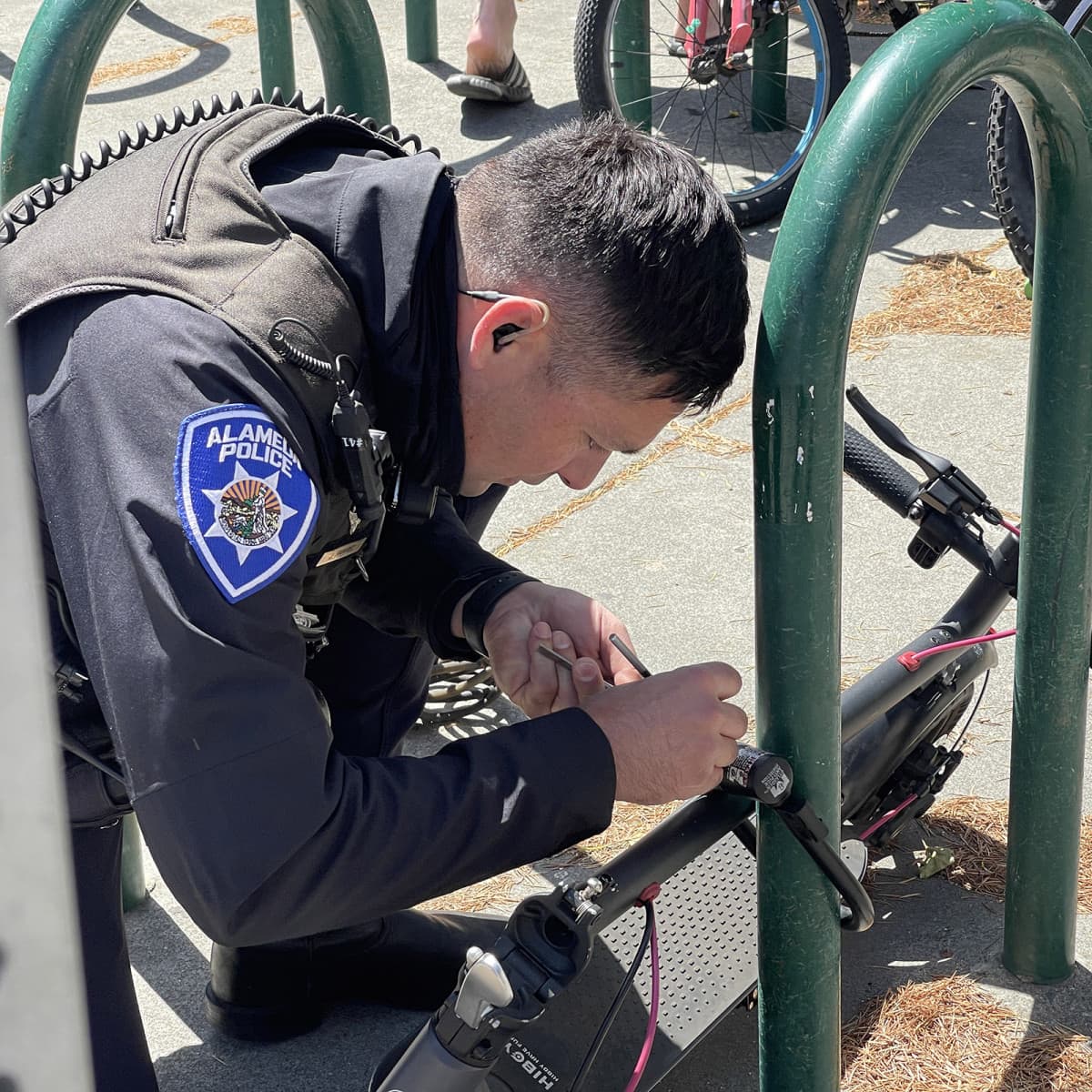 Alameda Post - APD officer removing broken key from bike lock