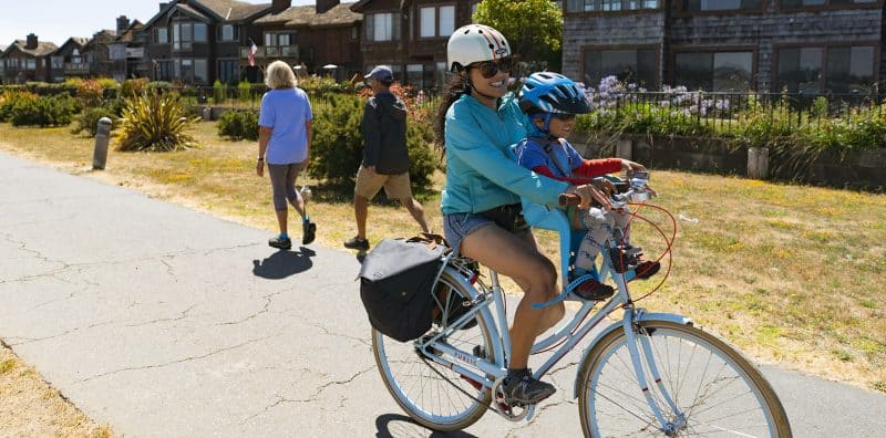 Alameda Post - a smiling mother and child on a bike 