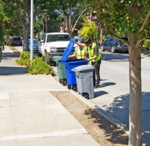 Alameda Post - Trash monitors checking bins