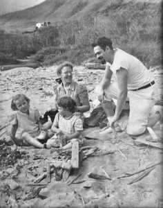 Alameda Post - a black and white photo of a mother, father, and two children at the beach