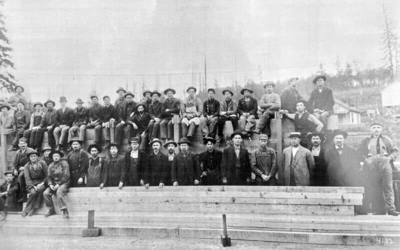 Alameda Post - a black and white group photo of about 40 men posing with lumbar 