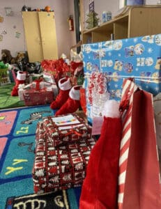 Alameda Post - the Jammie Drive. wrapped presents and stockings line a room