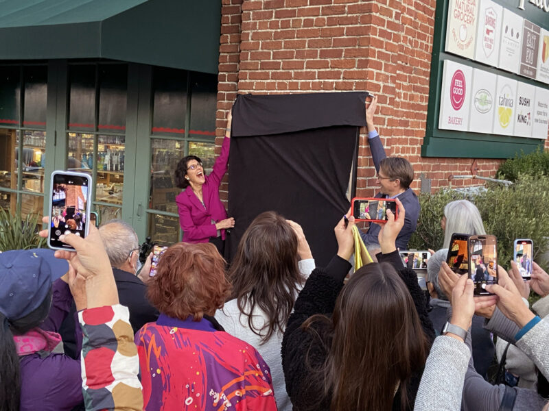 Alameda Post - a crowd gathers to watch a man an women unveil a historical marker