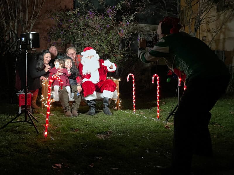Alameda Post - Santa visits a family with a young child and poses for a portrait with them