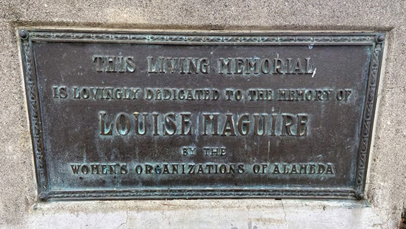 Alameda Post - a plaque at the Rockery which reads "This living memorial is lovingly dedicated to the memory of Louise Maquire by the women's organizations of Alameda."