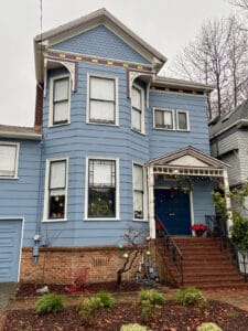 Alameda Post - a blue house with red brick stairs