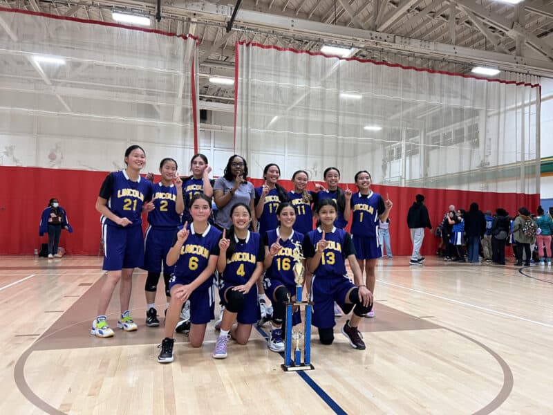 Alameda Post - the Lincoln Middle School Lions basketball team poses with their trophy