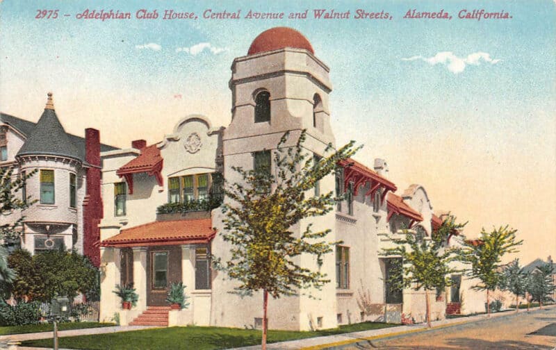 Alameda Post - a color postcard of a large red and white building 