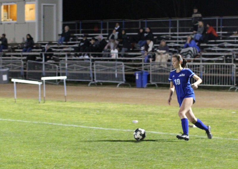 Alameda Post - a Encinal Jets soccer player in a blue uniform approaches a soccer ball