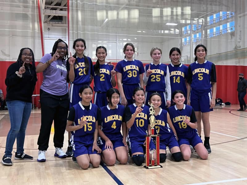 Alameda Post - the Lincoln Middle School Lions basketball team poses with their trophy