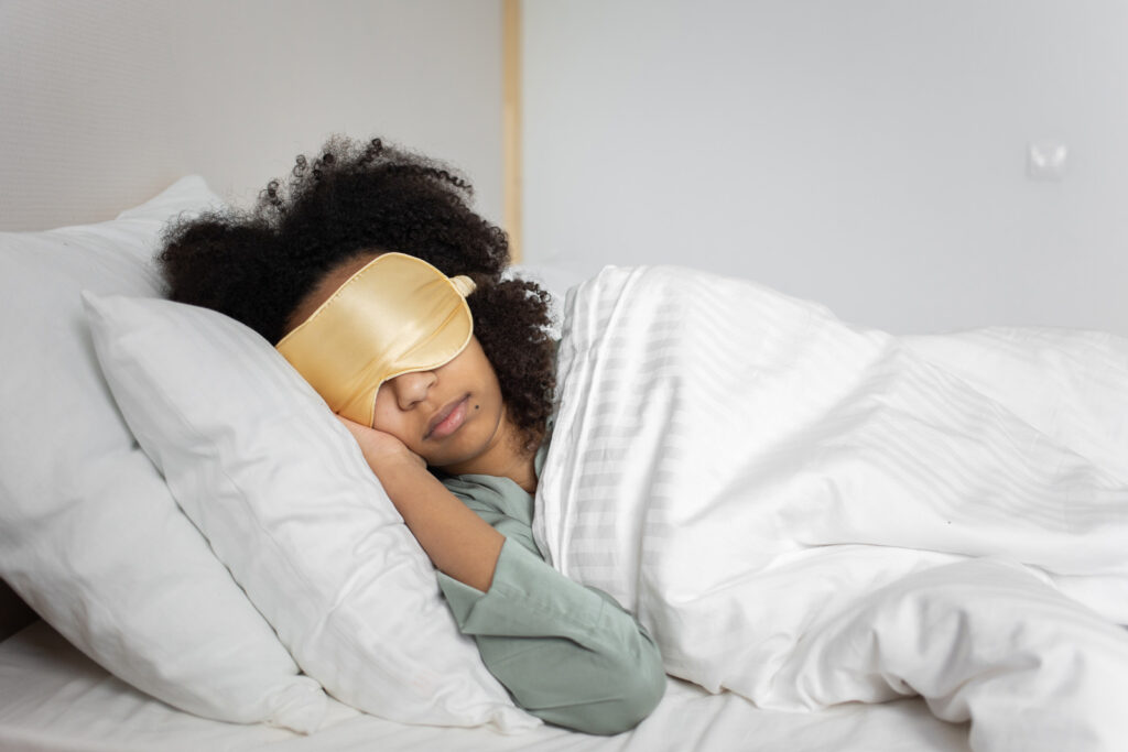 Alameda Post - a photo of someone in bed sleeping wearing a sleep mask