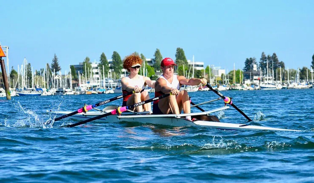 Alameda Post - two rowers rowing on the water. Rowers can be put into danger when debris and anchored-out vessels get in their way. 