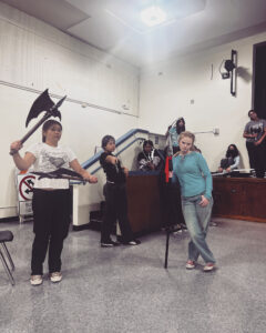 Alameda Post - another rehearsal photo. An actor holds a large battle ax.