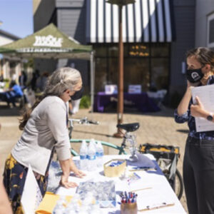 Alameda Post - a person goes to a job fair booth