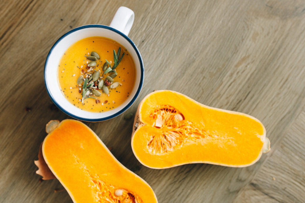 Alameda Post - a bowl of butternut squash soup next to a butternut squash