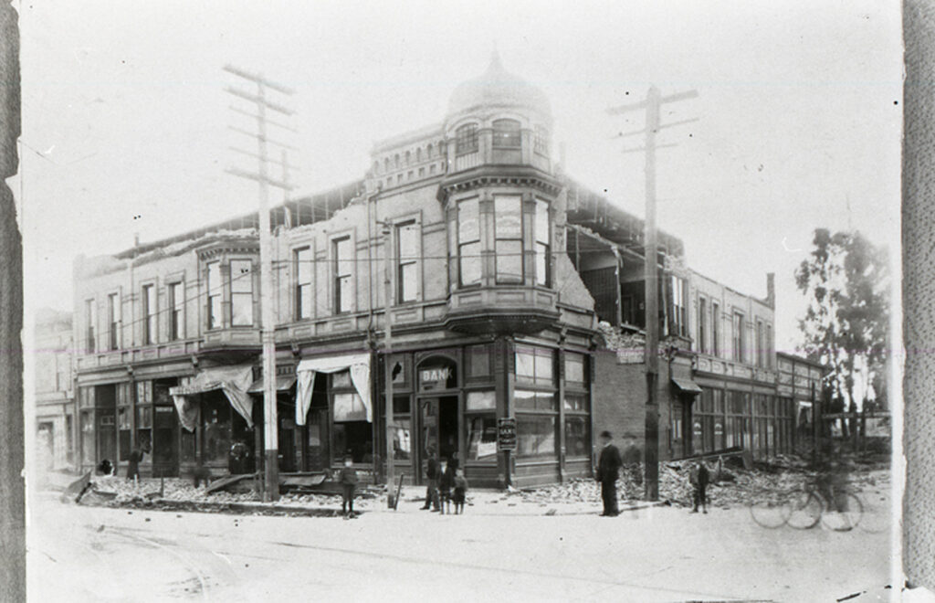 Alameda Post - a black and white image of a building partially destroyed by an earthquake