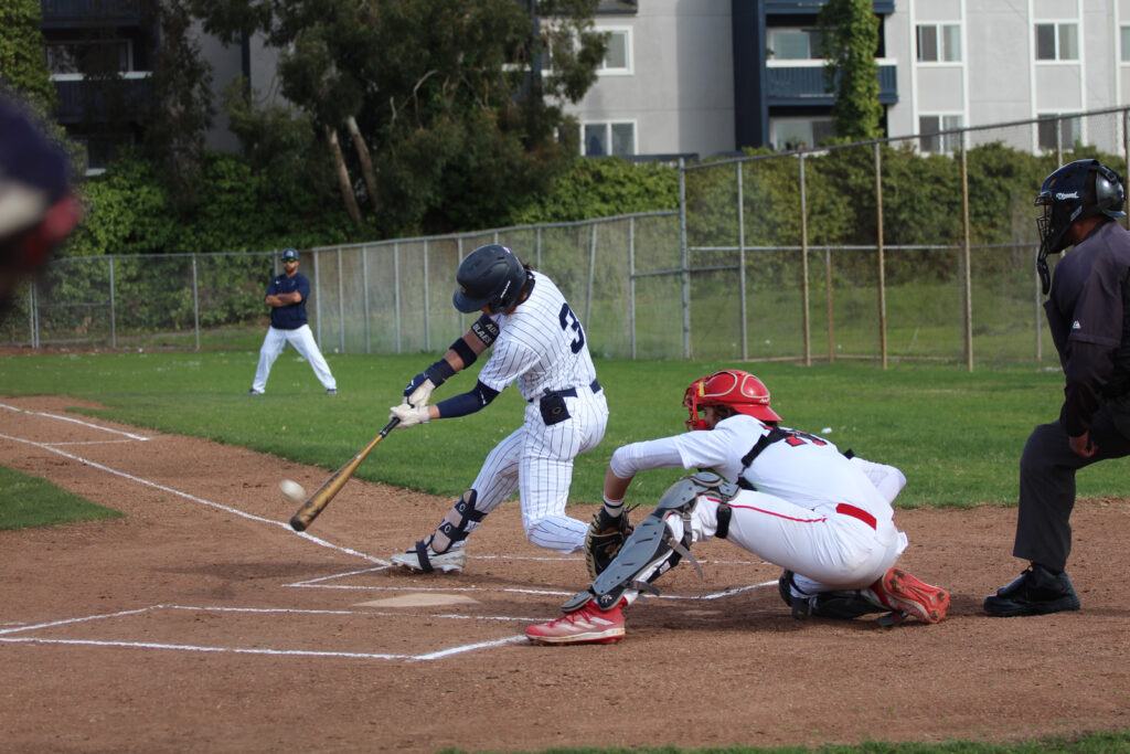 Alameda Post - a baseball player hits the ball