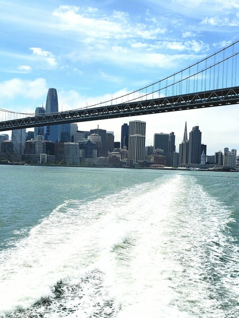 Alameda Post - the wake behind the SF Bay Ferry as the camera looks out at the bridge and city