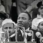 Alameda Post - Martin Luther King Jr. giving a speech behind a podium of microphones