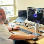 Alameda Post - Adam Gillitt sits at a desk