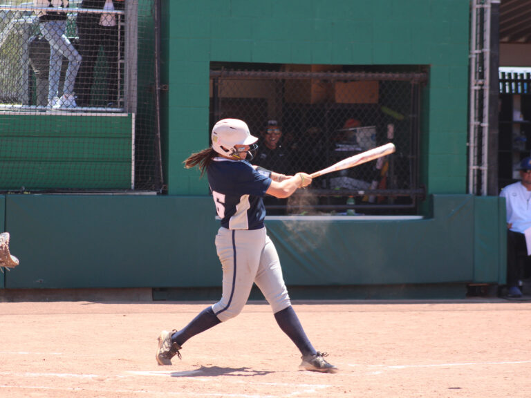 Alameda Post - a softball player swings a bat