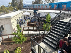 Alameda Post - the courtyard with ramps, a bbq grill, chairs, and tents for the grand opening event