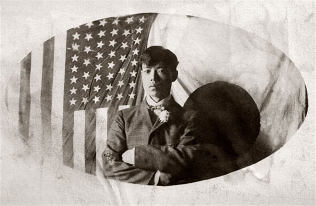 Alameda Post - a black and white photo of a man in front of an American flag