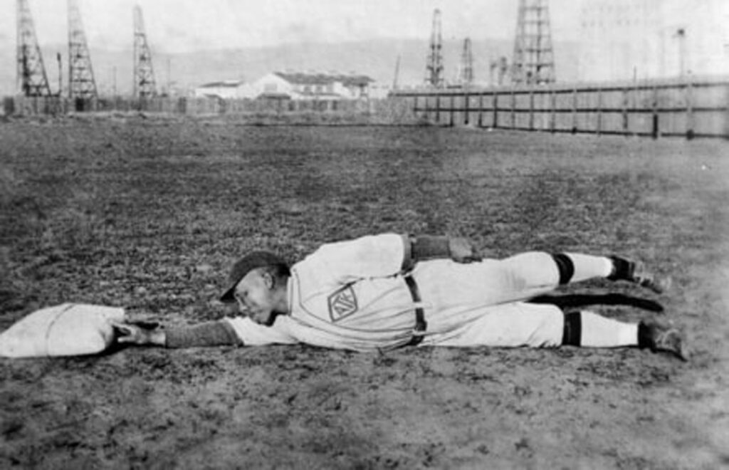 Alameda Post - a baseball player laying stretched out on a field