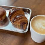 Alameda Post - two pastries next to a Firebrand coffee on a wooden table