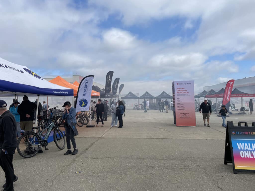 Alameda Post - Electrify Expo booths and attendees and a fog of white smoke
