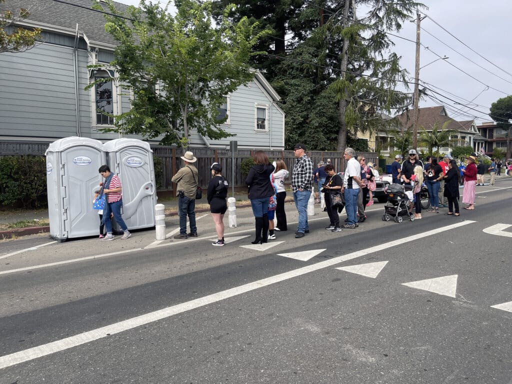 Alameda Post - Bear's-Eye View of Alameda for July 9, 2023 – Mouf's 4th of July Parade Report - waiting for the portapotty