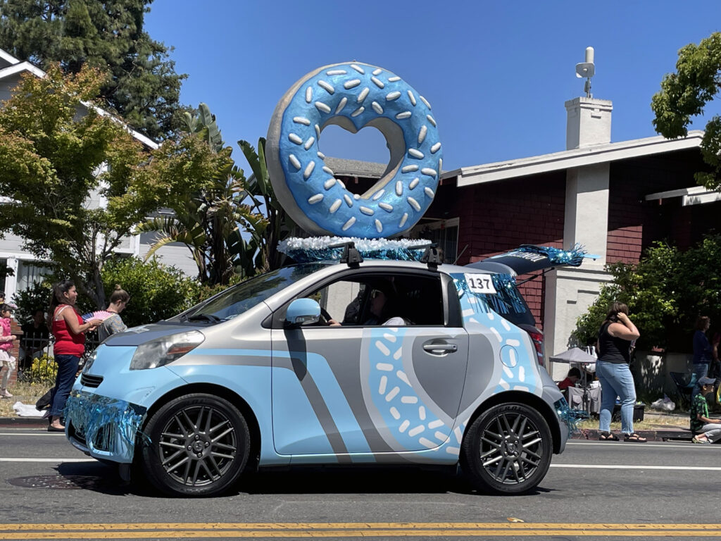 Alameda Post -a small blue car with a donut on top