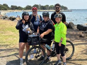 Alameda Post - 5 people in a group photo with Jenn Levine and her bike at the center