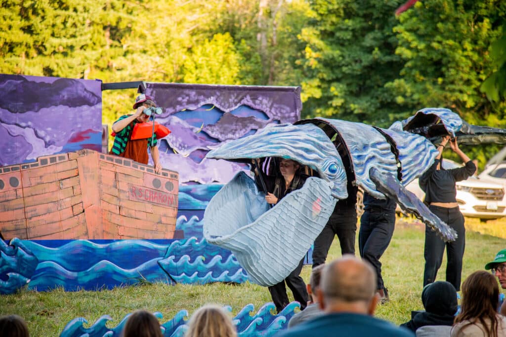 Alameda Post - Ship of Fools: A Giant Puppet Odyssey performance with performers in a boat and a large puppet whale