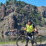 Alameda Post - Jenn Levine stands next to her bike in the Rockies