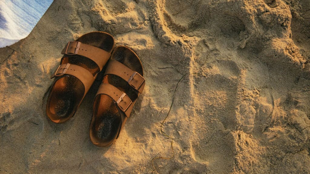 Alameda Post - a pair of sandals in the sand