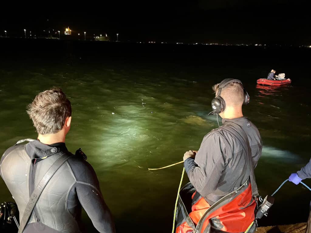 Alameda Post - AFD members shine a light into the water at the lagoon