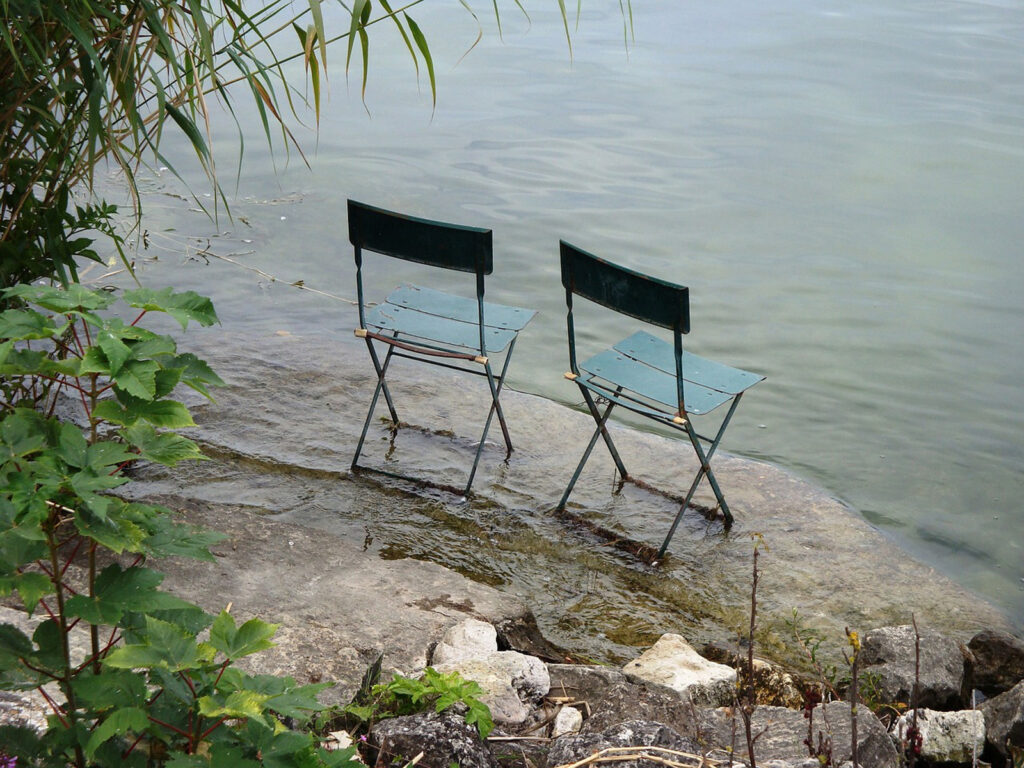 Alameda Post - two empty chairs side by side looking over a pond. Read on for more advice on difficult converstaions