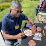 Alameda Post Tom Varghese smiles and makes a craft