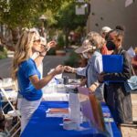 Alameda Post - visitors to a job fair visit a booth at South Shore Center