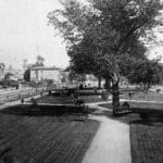 Alameda Post - a black and white photo of what is now Chochenyo Park. Landscaping, trees, and benches decorate the scene.
