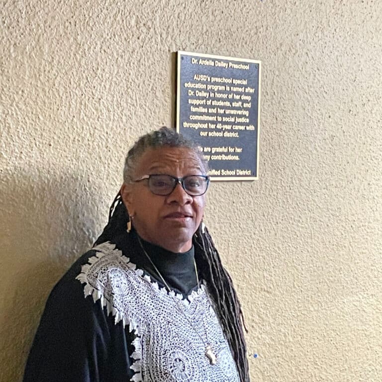 Alameda Post - Dr. Ardella Dailey stands in front of the plaque dedicating a preschool program to her