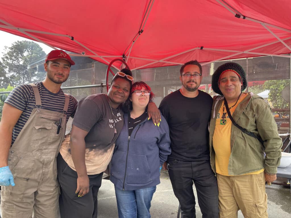 Alameda Post - five people stand under a tent at the Farm2Market Harvest Festival