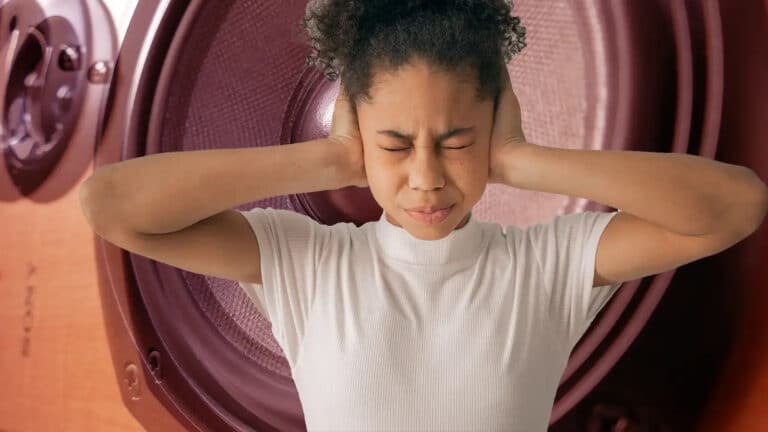 Alameda Post - a woman covers her ears in front of a speaker