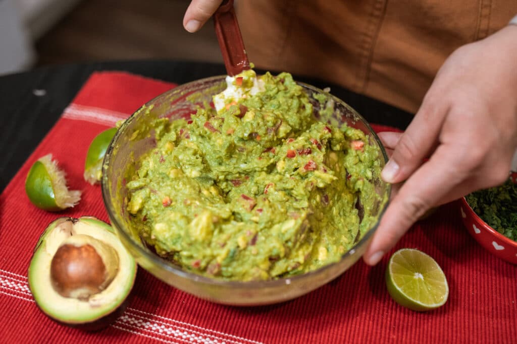 Alameda Post - someone mixes a bowl of guacamole