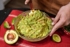 Alameda Post - someone mixes a bowl of guacamole