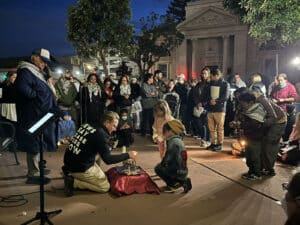 Alameda Post - a crowd gathers around as a menorah is lit in front of City Hall