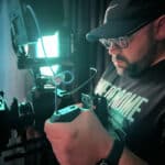 Alameda Post - Chris Decker looks into a camera while filming