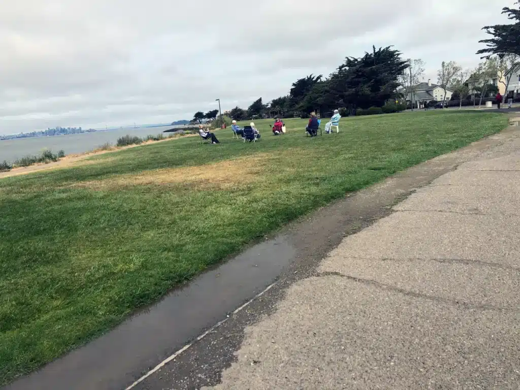Alameda Post - A group of people socially distancing themselves outside