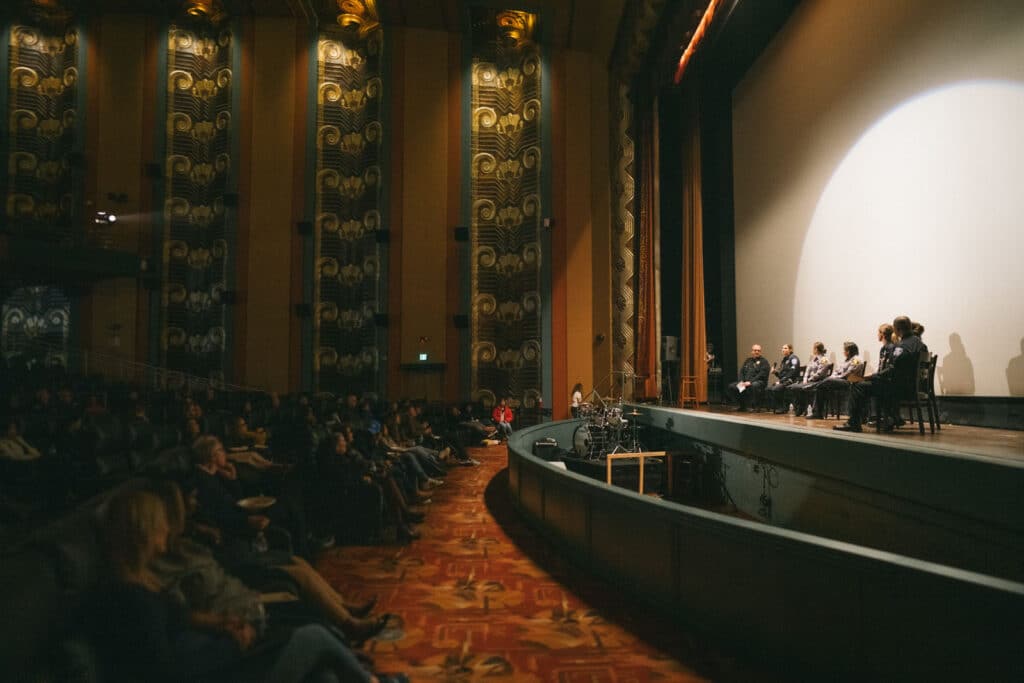 Alameda Post - at the Alameda Theatre, audience members listen as female first responders on stage talk